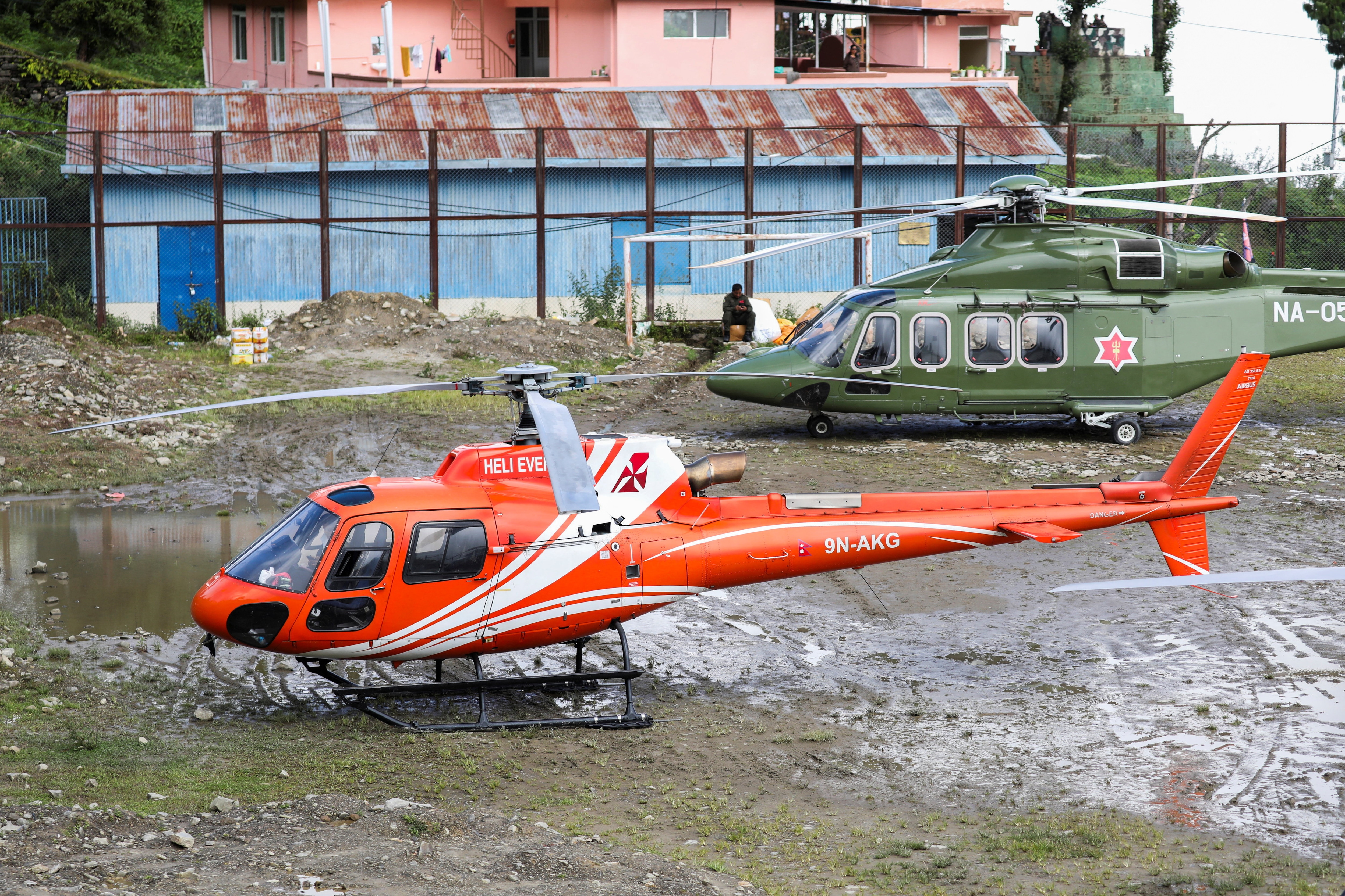 Helicopters are parked on open ground used by the Nepal Army to conduct rescue operations and transport relief supplies to Dhunche, a flood-affected area in Rasuwa district, Nepal, September 1, 2026. (REUTERS)