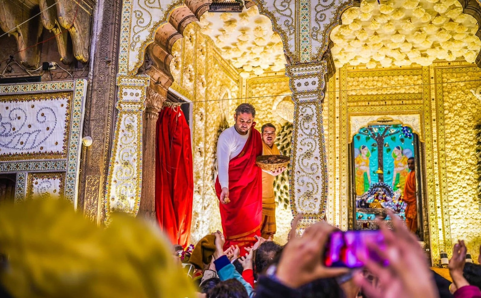 Pundrik Goswami distributing bhog to devotees at the Radha Raman Temple (Photo: Radha Raman Temple)