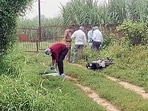 Forensic team and police personnel inspect the encounter site where a motorcycle lies on the ground after two prime shooters in the Ankit Balyan murder case were killed, in Shamli recently. (ANI Video Grab)
