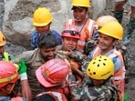Survivor Sanjay Sah is carried by members of a search and rescue team after they rescued two people alive who had been trapped inside a tunnel in Rasuwa, Nepal.
