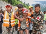 Nepal army personnel and other officials rescue a man from the tunnel of the Trishuli 3A Hydropower Project, in the aftermath of the recent flash floods, in Rasuwa district. (HT Photo)