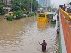 School buses remain stuck on a waterlogged road following heavy monsoon rain at Subhash Chowk near Sector 47 in Gurugram.