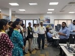 The delegation being briefed by the officials at the Vizhinjam International Seaport (HT Photo)