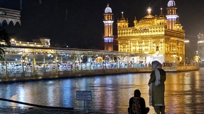 Women sit near the sarowar of the illuminated Golden Temple during a spell of monsoon rain, in Amritsar. (ANI) Women sit near the sarowar of the illuminated Golden Temple during a spell of monsoon rain, in Amritsar. (ANI)