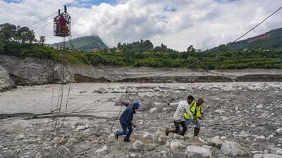 Nuwakot: Workers pull ropes as people use a makeshift zipline to cross the Trishuli river from Koloni in the aftermath of the recent flash floods, in Nuwakot district, Nepal, Friday, Sept. 4, 2026. (PTI Photo/Karma Bhutia) (PTI09_04_2026_000065B) (PTI) Nuwakot: Workers pull ropes as people use a makeshift zipline to cross the Trishuli river from Koloni in the aftermath of the recent flash floods, in Nuwakot district, Nepal, Friday, Sept. 4, 2026. (PTI Photo/Karma Bhutia) (PTI09_04_2026_000065B) (PTI)