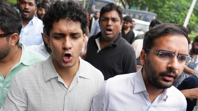 Cockroach Janta Party (CJP) spokespersons Saurav Das and Ashutosh Ranka along with party supporters move towards the Parliament Street police station as they stage a protest, demanding action against self-styled Hindutva influencer Swatantra Bhardwaj.