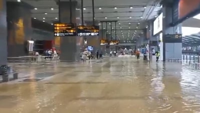 Delhi rains: Visuals from the airport showed people carrying luggage trolleys through ankle-deep water. (ANI video grab) Delhi rains: Visuals from the airport showed people carrying luggage trolleys through ankle-deep water. (ANI video grab)