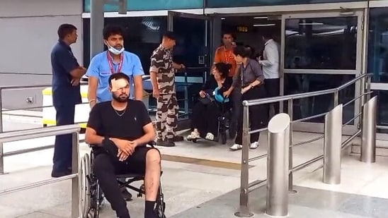Medical pesonnel present with an injured passenger in a wheelchair after several passengers, including crew members, got injured as Air India flight (AI2379) from Phuket to Delhi experienced a brief in-flight turbulence, in New Delhi. (ANI Video Grab)