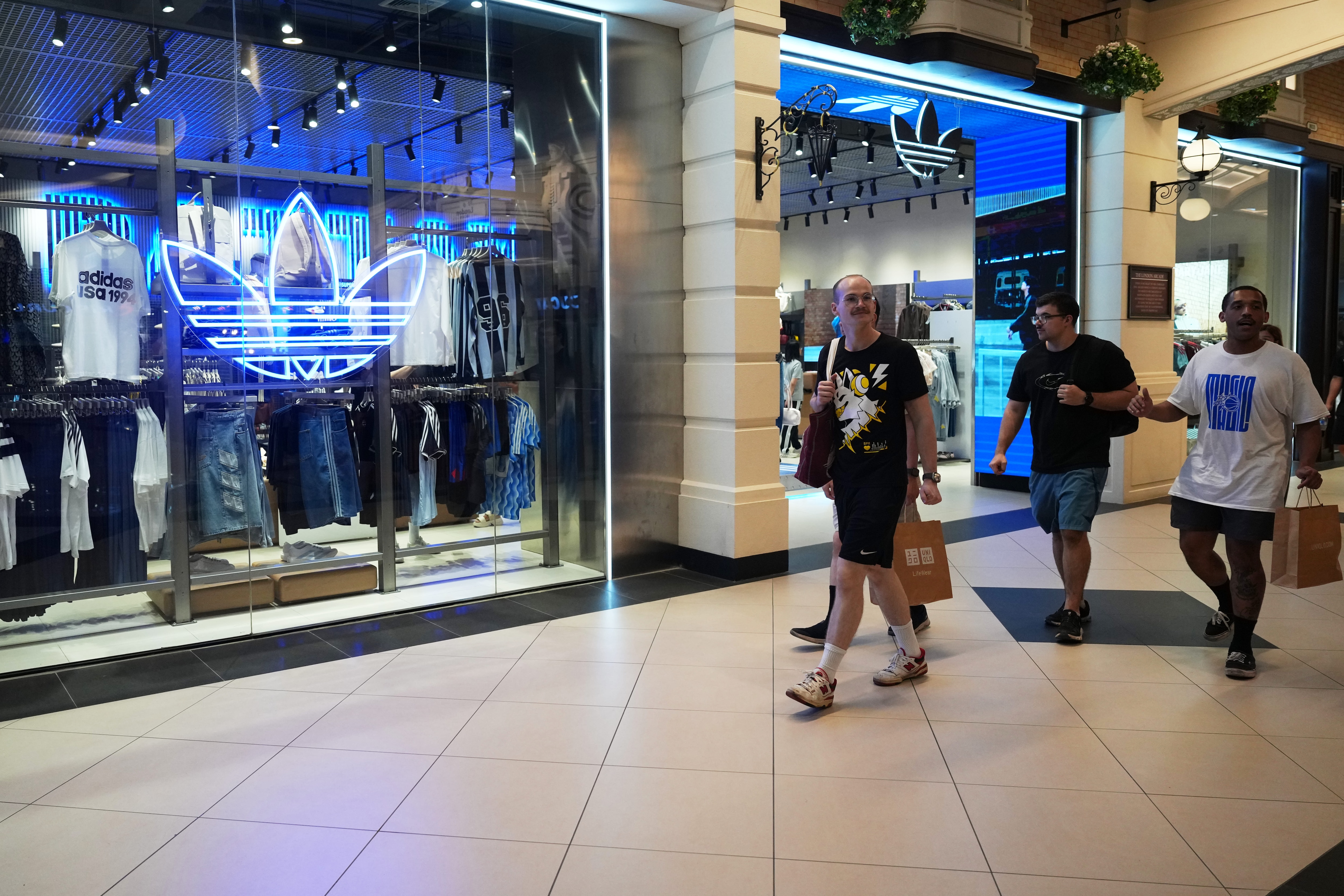 Crew members of the USS Abraham Lincoln walk at a shopping mall in Pattaya, Thailand, Thursday. (AP Photo)