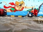 Gram it: Commuters wade through waterlogging at Hanuman Mandir, ISBT, after heavy rainfall on Friday. If one goes by the intensity at which Delhi is witnessing rainfall and waterlogging woes, it sure needs intervention of God Hanuman for commuters to crossover the pools of water that have lead city roads to get submerged. (Photo: Deepak/ANI)