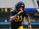 Staff members later appeared to place an air cast on Darius Wiley's leg before he was carted off the field.