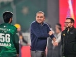 Pakistan's Interior Minister and Chairman of Pakistan Cricket Board Mohsin Naqvi, centre, chats with Pakistan's Babar Azam. 