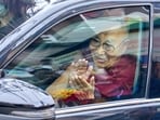 Tibetan spiritual leader the Dalai Lama greets devotees from inside his car upon his arrival in Dharamshala on Friday. (AP Photo)