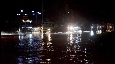 Commuters navigate through a waterlogged road in Chandigarh on Saturday. (Ravi Kumar/HT)