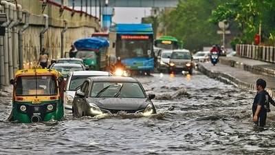 Commuters wade through a water logged stretch at Mayur Vihar Phase 2 near NH24 amid heavy rains in New Delhi on Friday. (Hindustan Times/Raj K Raj) Commuters wade through a water logged stretch at Mayur Vihar Phase 2 near NH24 amid heavy rains in New Delhi on Friday. (Hindustan Times/Raj K Raj)