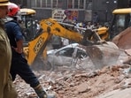 A JCB excavator removes debris from the site after a building collapsed near Satya Niketan at South-West Delhi, in New Delhi on Sunday. Rescue operations underway. 
