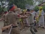 Farmers trying to break the barricades in Sangrur on Saturday. (HT Photo)