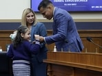 Marcus Coleman (R) shares a moment with his daughter Dalilah Coleman (L), who was permanently disabled after an illegal alien caused a multi-car crash, as his wife, Ileana Krause (2nd L) looks on   