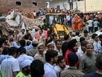 Delhi building collapse LIVE: People gather to watch as rescue personnel conduct a search operation at the site following a building collapse in the Satya Niketan area in New Delhi on September 6, 2026. 