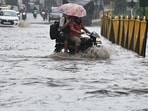 Vehicle wades through a waterlogged stretch after heavy monsoon rains at Gurugram-Sohna Road on Saturday. (Parveen Kumar/HT Photo)