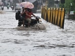 Vehicle wades through a waterlogged stretch after heavy monsoon rains at Gurugram-Sohna Road on Saturday.