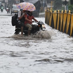 Vehicle wades through a waterlogged stretch after heavy monsoon rains at Gurugram-Sohna Road on Saturday.