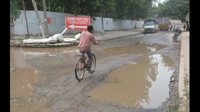 A severely damaged road in Industrial Area, Phase 1, Panchkula on Sunday. (Sant Arora/HT)