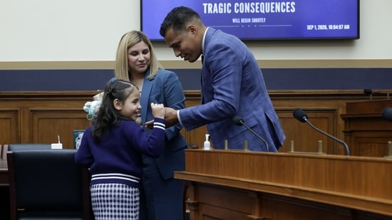 Marcus Coleman (R) shares a moment with his daughter Dalilah Coleman (L), who was permanently disabled after an illegal alien caused a multi-car crash, as his wife, Ileana Krause (2nd L) looks on (Alex Wong/Getty Images/AFP )