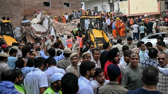 Delhi building collapse LIVE: People gather to watch as rescue personnel conduct a search operation at the site following a building collapse in the Satya Niketan area in New Delhi on September 6, 2026.