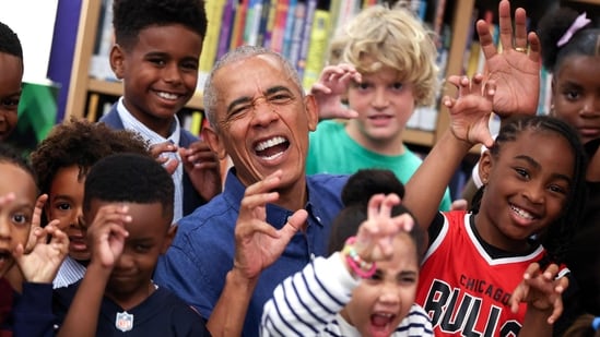 Former US President Barack Obama poses for photographs after reading to school children at the Barack Obama Presidential Center in John Lewis Plaza on June 19, 2026 in Chicago, Illinois. This is the first day the Barack Obama Presidential Center is open to the public. (Photo by Win McNamee / POOL / AFP)