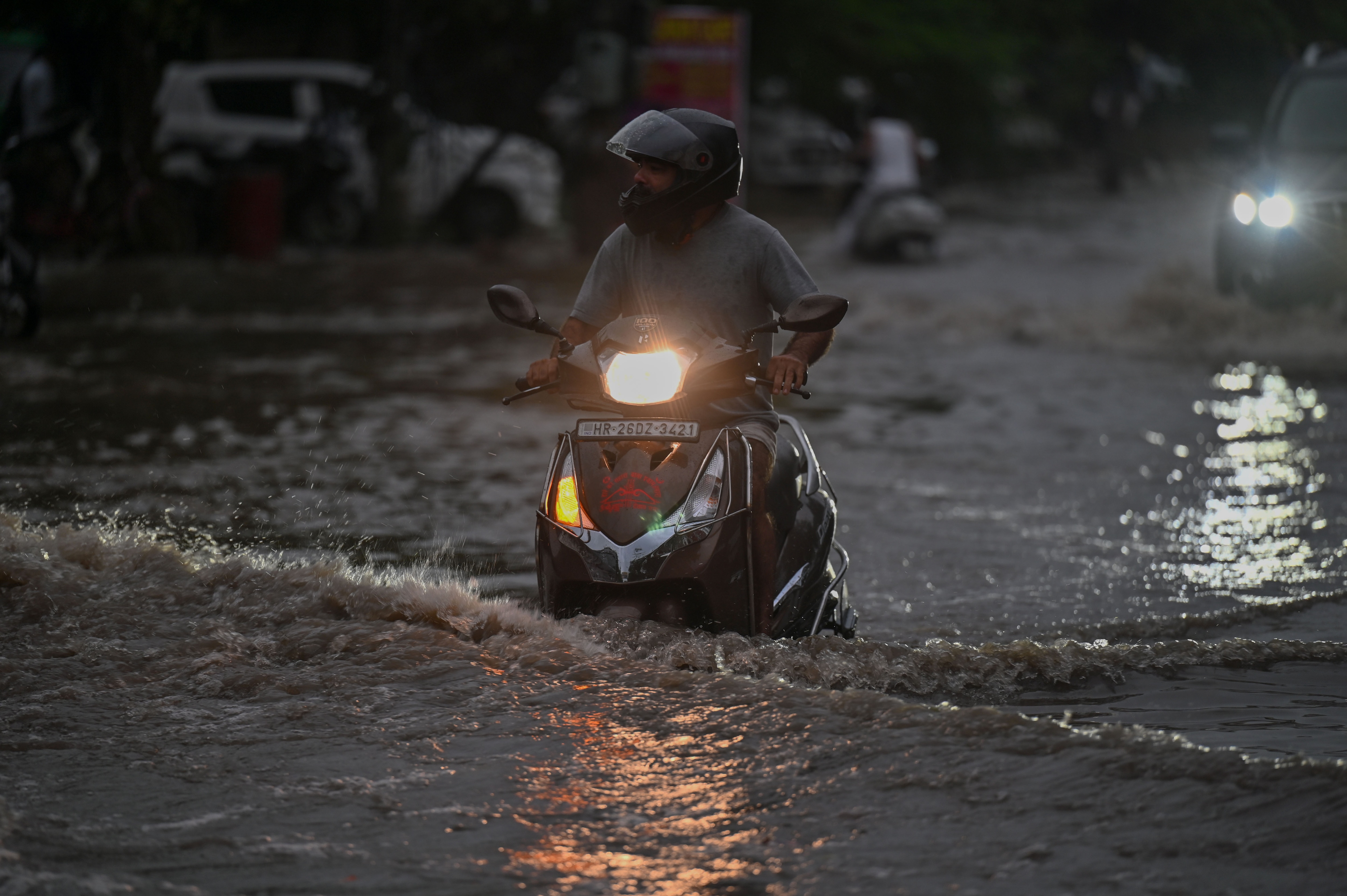 Vehicles wade through a waterlogged stretch during heavy monsoon rainfall on the Sector-10 road near Shri Shri 1008 Baba Ratan Das Prachin Mandir, in Gurugram, India, on Friday, 04 September 2026. (Parveen Kumar/HT)