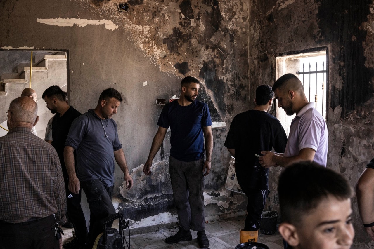 Men inspecting a house in a Palestinian village near the Israeli settlement of Havat Gilad that was burned on July 24. The Israeli military said it had dispersed a confrontation in the village between Palestinians and dozens of Israelis a day earlier.