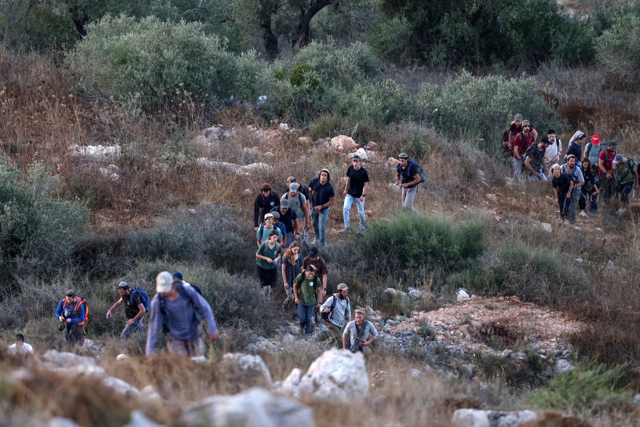 Israelis hiking between Palestinian villages in the military-occupied West Bank on July 31.