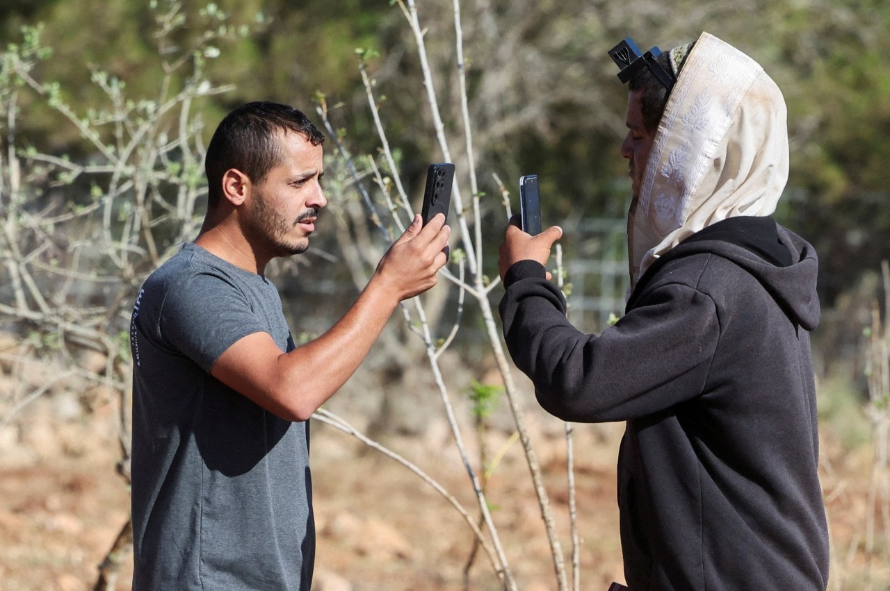 Yousef Hassan, a Palestinian, records one of the Israeli settlers entering Loui Ridi’s property on Aug. 18.