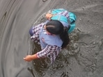A schoolgirl wades through a waterlogged street on her way to school in Varanasi on Monday. (Rajesh Kumar/ HT photo)