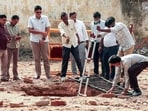 Archaeological Survey of India (ASI) officials inspect the structural openings of an ancient brick-lined well that was discovered (6th Sep) during the demolition drive of a mosque at the Collectorate complex, in Saharanpur on Monday. (ANI Video Grab)