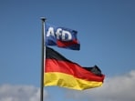 An Alternative for Germany (AfD) party flag and the German national flag on a flagpole in Bellingen, Germany, on Sept. 6, 2026. (Bloomberg)