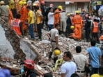 Rescue personnel conduct a search operation in the Satya Niketan area in New Delhi.