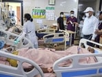 Injured people receive medical treatment at a hospital after a pickup vehicle with passengers from Rajasthan heading to Badaun overturned after hitting a road divider, killing twelve people, in Baghpat , Monday. (PTI Photo)