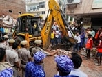 NDRF, fire department officials during a rescue operation after a 50-year-old five-storey building housing a boys' hostel collapsed in a congested bylane in Satya Niketan.