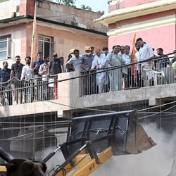 Delhi Chief Minister Rekha Gupta oversees the rescue operations ongoing at the building collapse site in Satya Niketan, in New Delhi on Monday. 

