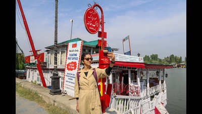 A tourist takes a selfie near the Floating Post Office on the banks of Dal Lake in Srinagar. (Waseem Andrabi/HT)