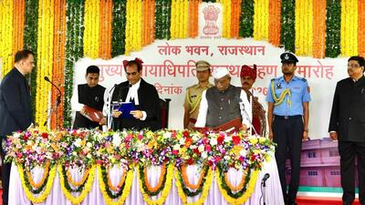 After taking the oath, Justice Agrawal signed the warrant of appointment issued by the President. (HT photo)