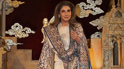 Dimple Kapadia styled a black chamois 'Godart' coat with hand-embroidered Bandhani motifs, paired with a black quilted waistcoat and a sarong skirt. (abujanisandeepkhosla/Instagram) Dimple Kapadia styled a black chamois 'Godart' coat with hand-embroidered Bandhani motifs, paired with a black quilted waistcoat and a sarong skirt. (abujanisandeepkhosla/Instagram)