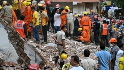 Rescue personnel conduct a search operation in the Satya Niketan area in New Delhi. (AFP) Rescue personnel conduct a search operation in the Satya Niketan area in New Delhi. (AFP)
