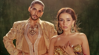Influencer Komal Pandey paired a heavy red lehenga with golden blouse, while her partner Siddharth Batra spotted in beige ensemble. (komalpandeyofficial/Instagram) Influencer Komal Pandey paired a heavy red lehenga with golden blouse, while her partner Siddharth Batra spotted in beige ensemble. (komalpandeyofficial/Instagram)