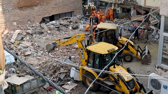 JCB machines remove debris during rescue operations at the site of a building collapse near Satya Niketan in South-West Delhi, in New Delhi on Monday.