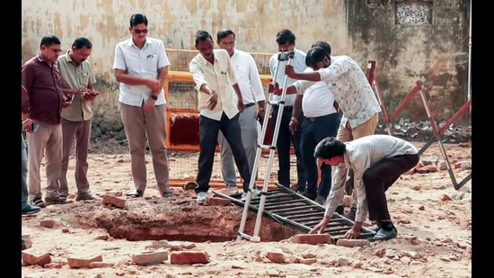 Archaeological Survey of India (ASI) officials inspect the structural openings of an ancient brick-lined well that was discovered (6th Sep) during the demolition drive of a mosque at the Collectorate complex, in Saharanpur on Monday. (ANI Video Grab)