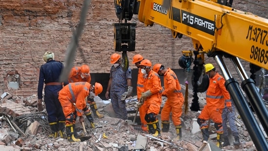 National Disaster Response Force (NDRF) teams remove debris while searching for signs of life in the basement during morning search and rescue operations at the site of a collapsed building in Satya Niketan, New Delhi, India, on Monday, September 7, 2026. (Hindustan Times)