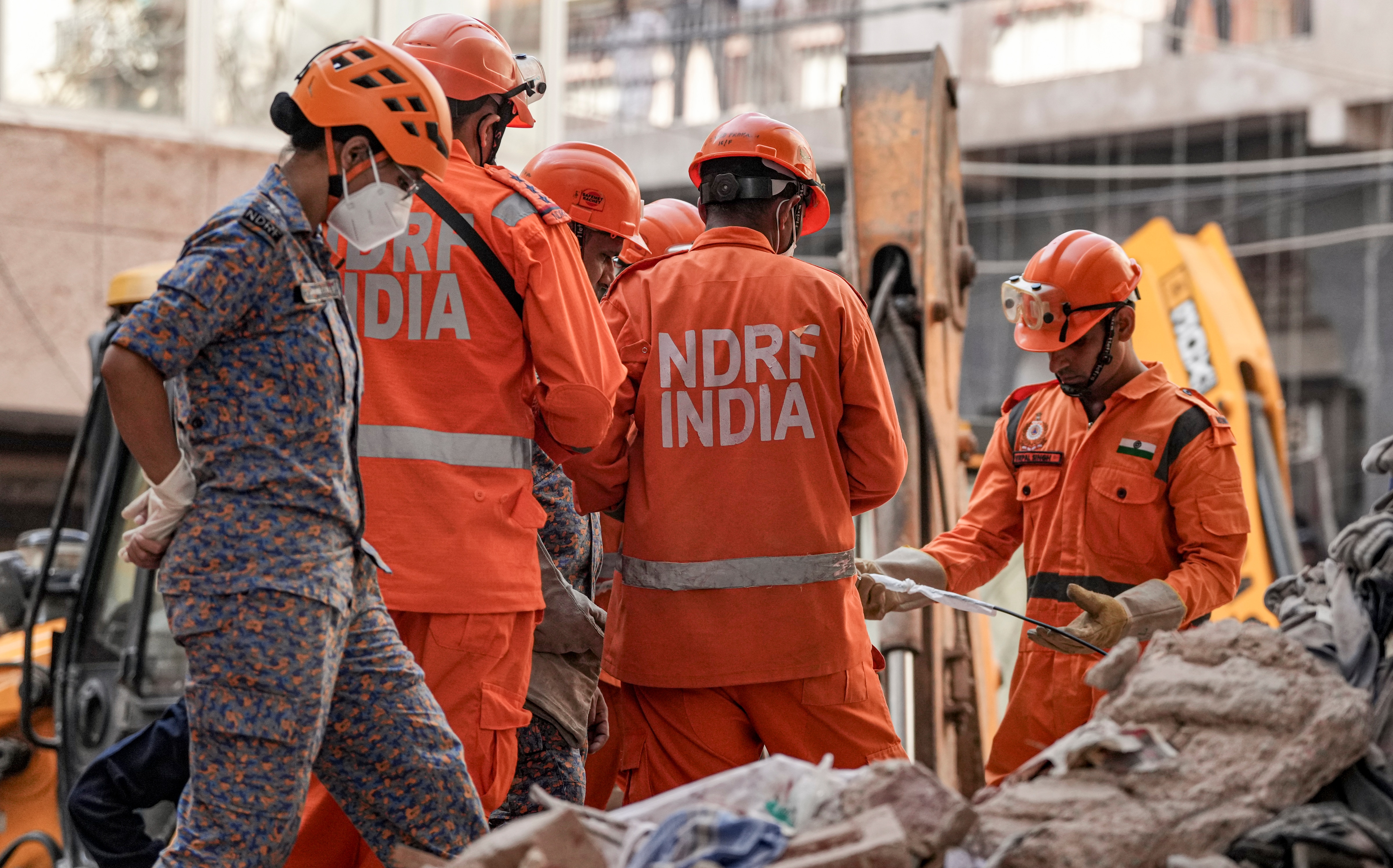 Rescue personnel conduct a rescue operation on the second day after a 50-year-old five-storey building collapsed. (PTI)